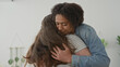 © Krakenimages.com - Man gently hugging plus size woman showing bare shoulder, hand cradling back in sunlit studio; support together comfort.