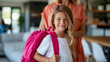 © Nataliya - Faceless happy little schoolgirl getting ready for school with help of mother as smiling student with colorful backpack in cozy interior represents back to school concept family
