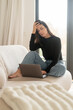 © gzorgz - Brunette haired young woman working at home and looking at her laptop screen, feeling disappointed