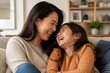 © Formoney - Warm indoor setting with mother and daughter sharing laughter. Mother smiles gently, head close to child's. Daughter laughs freely, eyes closed in joy. Cozy couch with soft textures and homey backdrop
