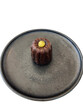 © Haylee - Single canelé dessert on a dark plate