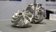 © DigitalSpace - Medium shot of metallic 3Dprinted pump impeller and casing assembly showcasing precision engineering and durable additive manufacturing techniques on a professional display table.