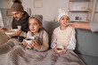 © Pixel-Shot - Ill little girl taking cough syrup from her mother at home