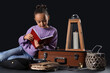 © Pixel-Shot - Cute little girl reading adventure book on dark background