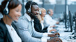 © pattozher - Customer Service Professionals: A diverse team of call center agents wearing headsets and smiling while working on computers in a modern office environment, providing efficient customer support.