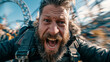 © Olga Ко - Very emotional bearded man screaming during a thrilling roller coaster ride, action camera POV