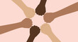 © Mustari Studio - Diverse hands clasped together in unity on a paper background with a pen writing