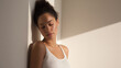 © tojirapong - A serene moment of introspection captured in soft natural light, highlighting a woman's peaceful expression and relaxed posture.