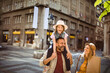 © Davor - Happy family sightseeing and shopping in city street