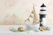 © tomertu - summer background with boat, blue sea glass and shells