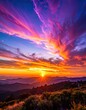 © Bucek - Vibrant sunset over a mountainous landscape with dramatic clouds.