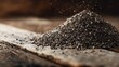 © phianguma - Pile of Black Chia Seeds on Rustic Wooden Surface with Texture
