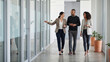 © starush - Leadership Walk-and-Talk in a Contemporary Office Hallway