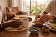 © AdPremium - Close-up of a diverse couple enjoying a healthy breakfast with steaming coffee and fresh sourdough bread in a sunlit modern apartment
