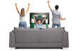 © Ljupco Smokovski - Happy boy with a man and woman cheering in front of tv