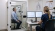 © Jeff - adult patient seated inside transparent body plethysmography chamber performing pulmonary function test through filtered mouthpiece