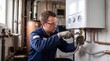 © tangmo.pa - Plumber installing a tankless water heater in a home utility room