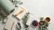 © pia - A serene morning setup with a yoga mat, notebook, and healthy snacks on a white surface