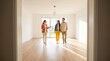 © Creatify_Tech - Real estate agent showing bright new apartment to young couple holding hands walking together on hardwood floors.