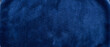 © Vexello - Velvet texture background presenting a rich navy blue fabric surface with soft vertical grain and gentle sheen across a plush luxurious backdrop