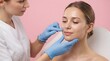 © TRIA - Aesthetic doctor examining patient face before cosmetic skin treatment