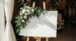 © Dimas - Elegant blank canvas with floral decoration on easel.
