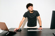 © Just images - Young man working on computer while talk with his colleagues