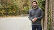 © Xenia - Man wearing grey pullover hoodie and jeans. Masculine casual style portrait outdoors. Everyday fashion for men