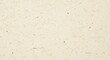 © Sathaporn Buarabut - High-resolution macro shot of a grainy recycled paper surface with visible natural fibers and a subtle cream-colored textured background, speckled, sepia, sheet