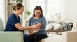 © OlgaNeuroArt - Lactation consultant helping a mother breastfeed her newborn baby at home. Professional postpartum support during World Breastfeeding Week