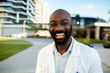 © Davor - Portrait of smiling doctor outside modern hospital