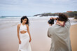 © Alvaro Lavin/Stocksy - Model posing for a photographer during a beach photoshoot