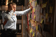 © Andrii Lysenko - Shocked Detective woman suffering stress while investigating case looking at evidence board investigation problem solving, track suspect and clue mapping in office at night.