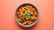 © MUsman - Korean tteokbokki with chewy rice cakes coated in thick glossy spicy gochujang sauce, garnished with sesame seeds