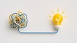 © Elite Studio - Tangled wire untangling into glowing yellow lightbulb. Concept of creative brainstorming, problem solving, and business solution.