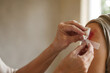 © Eduardo - Gentle hands carefully cleaning and bandaging wounded shoulder with gauze and medical tape, good samaritan compassion care concept, helping stranger biblical parable for healthcare blog