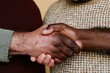 © Breezze - Close up of a firm handshake between two men with diverse skin tones for concepts of unity, peace, and mutual support in a professional or casual setting