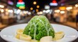 © Faiz Novareza - A refreshing bowl of green shaved ice dessert topped with sweet condensed milk and sliced banana served at a vibrant night market stall for customers enjoying a traditional local summer time