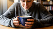 © Nasreen - Man holding a blue coffee mug. Adult male enjoying hot beverage.