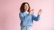 © MONIR - A cheerful young woman with curly reddish hair wearing a light blue knitted sweater, gesturing ad social media download thambnail template event festive festival 2026 2027 2028