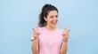 © MONIR - A cheerful young woman with her hair in a ponytail wearing a pink t-shirt standing against a ad social media download thambnail template event festive festival 2026 2027 2028