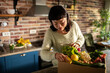 © Davor - Woman unpacking fresh produce delivery in home kitchen