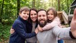 © AiDesign - Family selfie during camping and outdoor adventure for nature travel togetherness bonding and active vacation lifestyle memories
