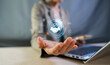 © MAUNG - Business Partnership and Successful Deal Concept with Digital Handshake Virtual Icons on Laptop