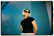 © Azamat Mukanov/Stocksy - Smiling Woman Wearing Wireless Headphones and Sunglasses
