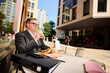 © Boris Jovanovic/Stocksy - Man eats a meal outside a cafe in London.