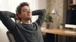 © Eve - Relaxed young caucasian male professional wearing glasses sitting comfortably in office chair with hands behind head and closed eyes enjoying peaceful break during successful work day.