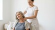 © Elenba - Female therapist massaging the neck of an elderly woman. Senior physical therapy and rehabilitation session. Elder care and wellness concept