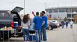 © Nei Mar - Group of friends enjoying a tailgate party outside stadium parking lot