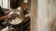© Fenti - Artisan hands cleaning a traditional brass gamelan instrument